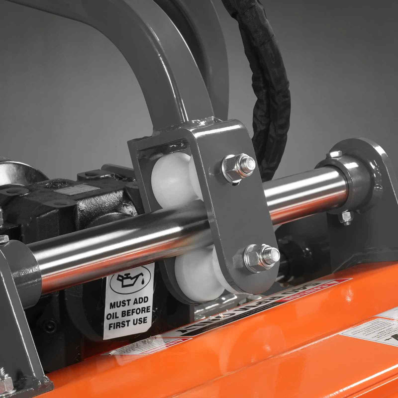 close-up of metal roller bracket and pivot assembly with oil warning label on orange MechMaxx 63-inch PTO flail mower gallery 1
