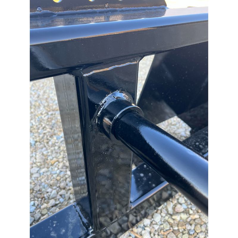 Close-up of Stinger Attachments BS1 Series 1 Skid Steer Bale Spear showing black welded steel components, gallery position 3