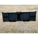 Wide black steel skid steer attachment with reinforced panels and serrated edges on gravel surface outdoors
