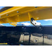 Close-up of yellow steel mounting bracket bolted to black steel snow pusher blade under a clear sky