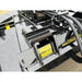 Close-up of Stinger Attachments TF5 Twister skid steer brush cutter showing fork slots and hydraulic hoses, gallery image 4.