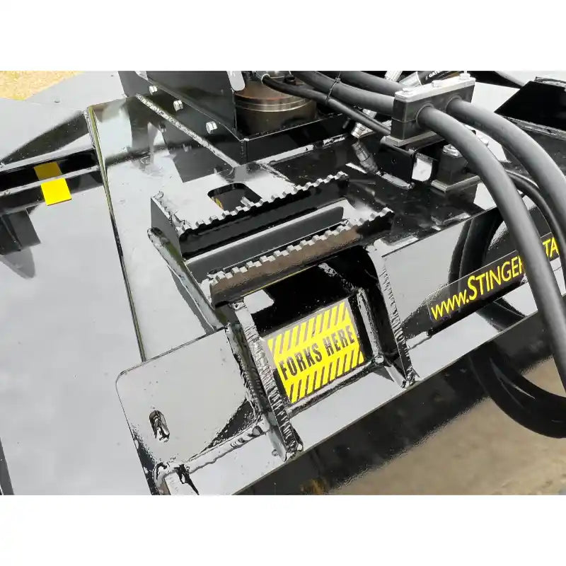 Close-up of Stinger Attachments TF5 Twister skid steer brush cutter showing fork slots and hydraulic hoses, gallery image 4.