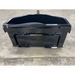 Black skid steer attachment with reinforced edges and mounting brackets on a concrete floor surface