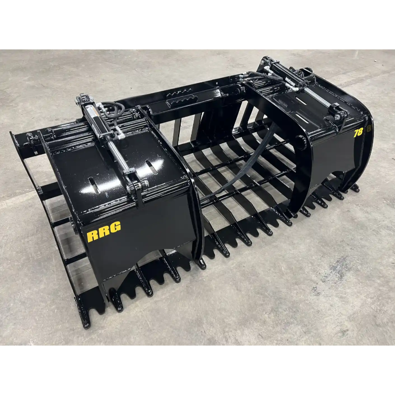 Black steel root and rock grapple attachment with dual hydraulic cylinders and spaced curved tines on concrete floor