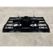 Front view of black steel skid steer land plane attachment with welded frame and mounting hooks on concrete floor