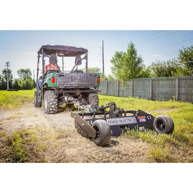 Swisher 48" Roadbuster Commercial Pro driveway grader attached to ATV with black frame and dual support wheels, gallery position 1