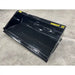 Black steel skid steer material bucket with smooth interior and yellow Series 2 72 markings on concrete surface