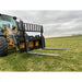 Black skid steer pallet fork attachment with perforated backrest and two extended steel tines on grassy field