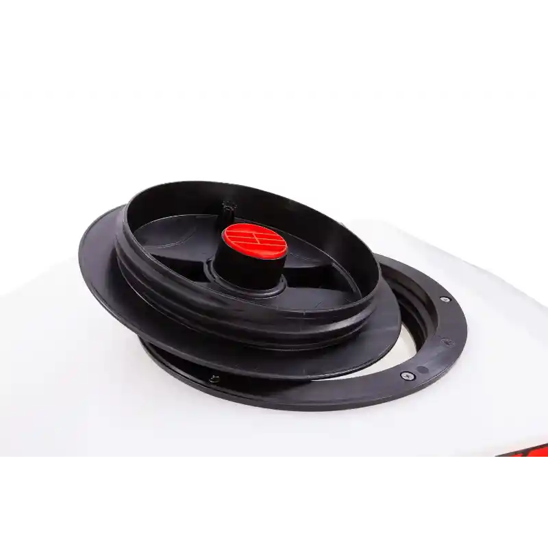 Close-up of black circular distribution plate and red center cap on white Swisher ATV spreader hopper, gallery position 1