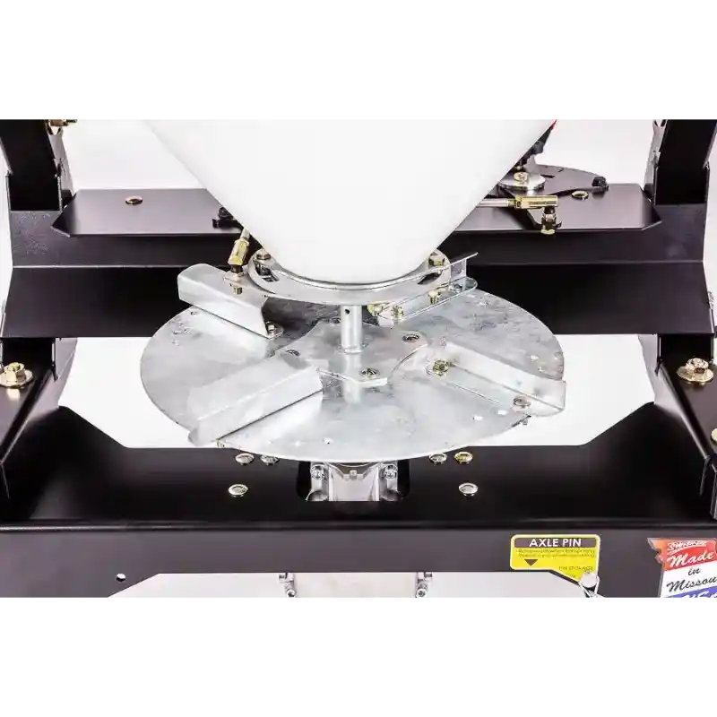 Metal spreader disk and mounting assembly under white hopper on Swisher 52-Gallon Tow-Behind Spreader, gallery position 1