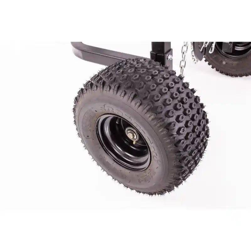 Close-up of knobby pneumatic tire and black steel rim on Swisher ATV Log Skidder, gallery position 1.