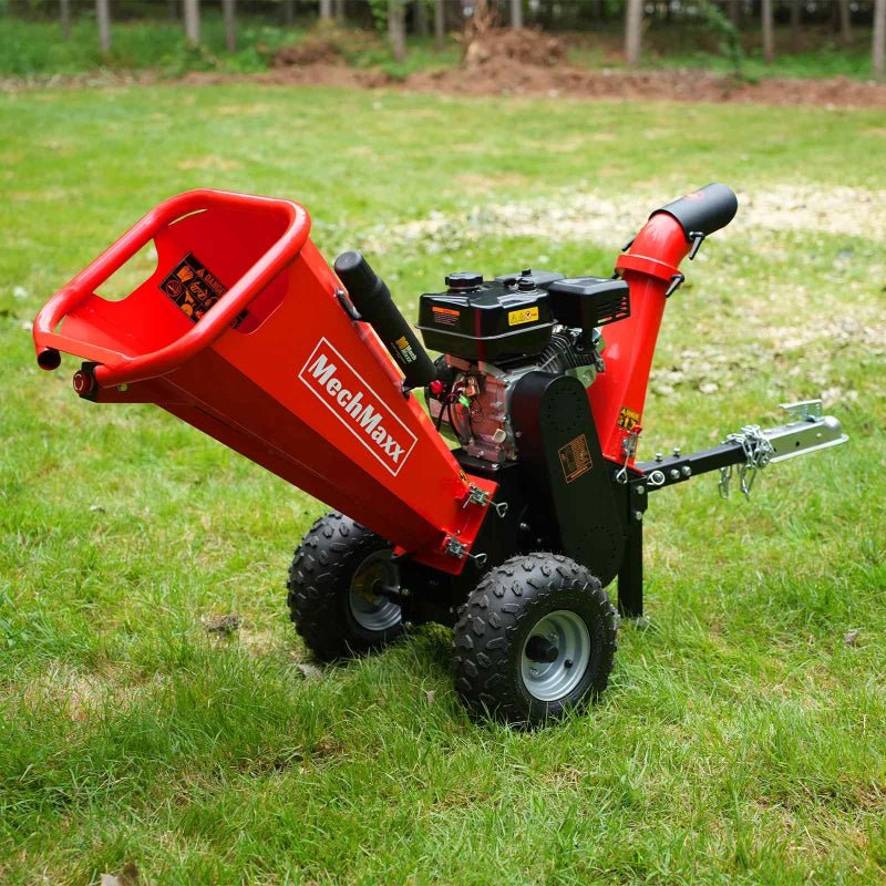 Gallery position 1 showing red MechMaxx GS650 7hp Ducar gas wood chipper with towbar and pneumatic tires on grass