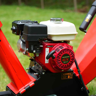 Close-up view of red and white Honda GX200 7hp gas engine mounted on MechMaxx GS650 wood chipper, gallery position 1
