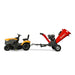 Side view of yellow lawn tractor towing red MechMaxx GS1500 15hp gas wood chipper with 5-inch chute, gallery position 1