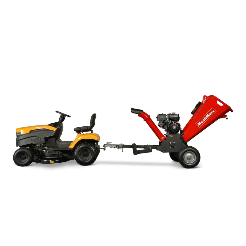 Side view of yellow lawn tractor towing red MechMaxx GS1500 15hp gas wood chipper with 5-inch chute, gallery position 1