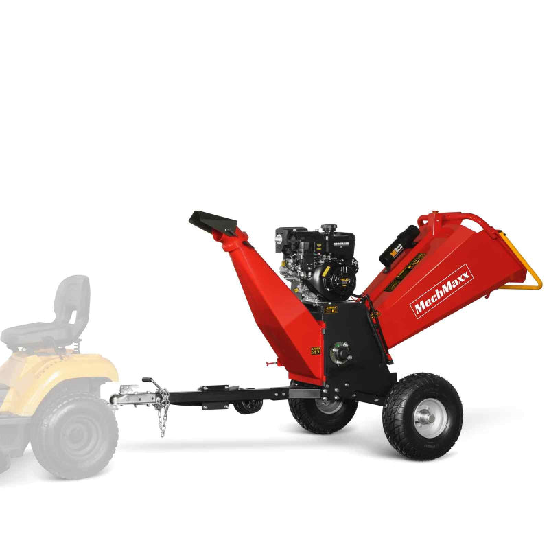 Side profile of red MechMaxx P4206 gas-powered drum wood chipper attached to yellow lawn tractor, gallery position 1