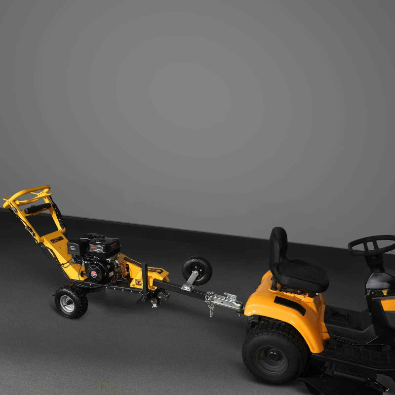 Tow-behind MechMaxx 420cc DUCAR E-Start stump grinder connected to yellow riding mower, gallery position 1