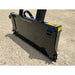 Black steel tractor-mounted tree puller attachment with smooth flat plate and reinforced mounting brackets on gravel surface