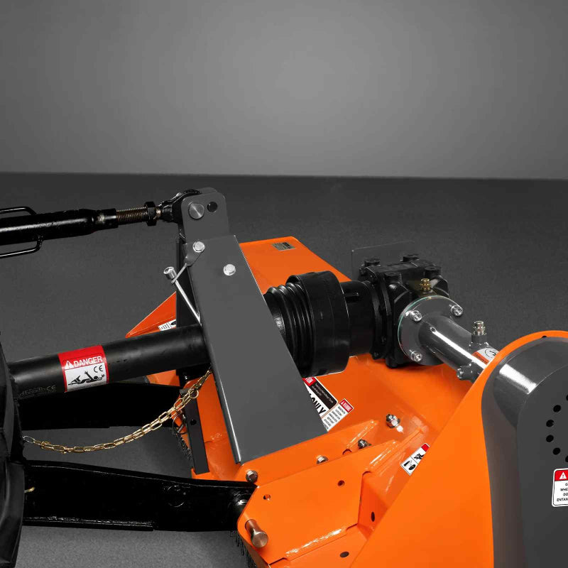 Close-up of PTO driveline connection and gearbox assembly on orange MechMaxx 68-inch flail mower, gallery position 1