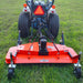 rear view of orange MechMaxx 72-inch PTO finishing mower attached to tractor with driveline and height adjustment wheels gallery position 1