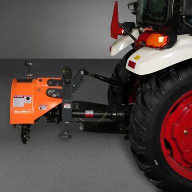 side profile of orange MechMaxx SG24 3-point PTO stump grinder attached to tractor rear gallery position 1