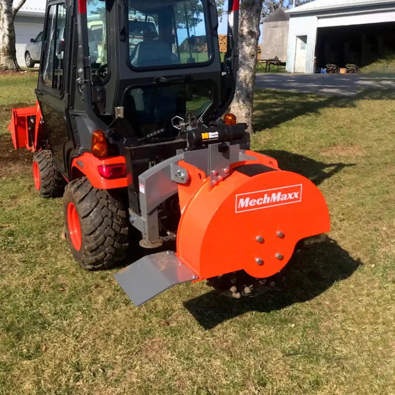 rear angled view of orange MechMaxx SG24 3-point PTO stump grinder mounted on utility vehicle gallery position 1