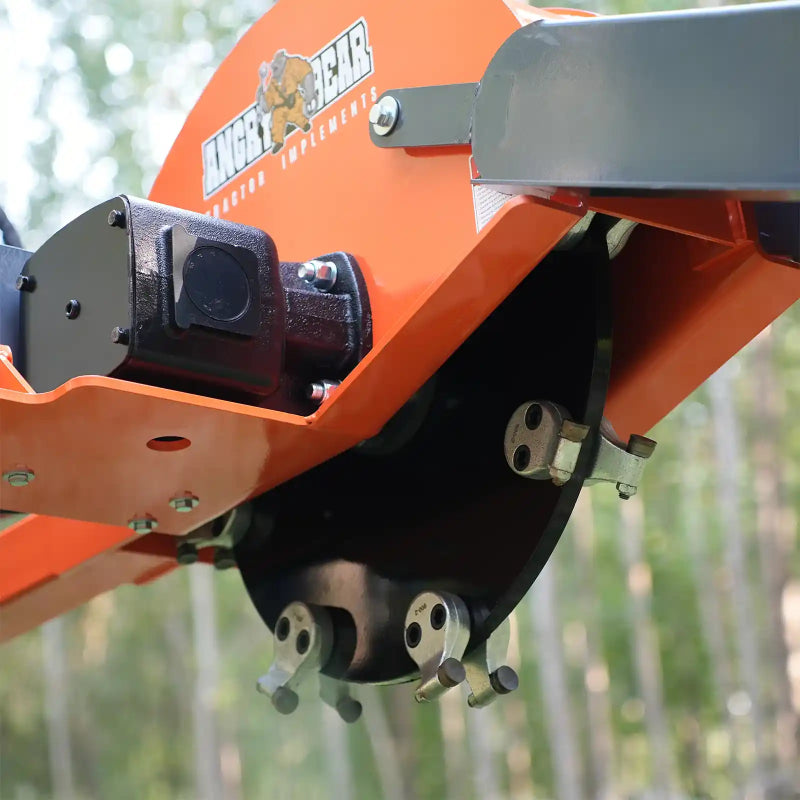 close-up of black cutting wheel with carbide teeth and orange mounting frame on stump grinder gallery position 1