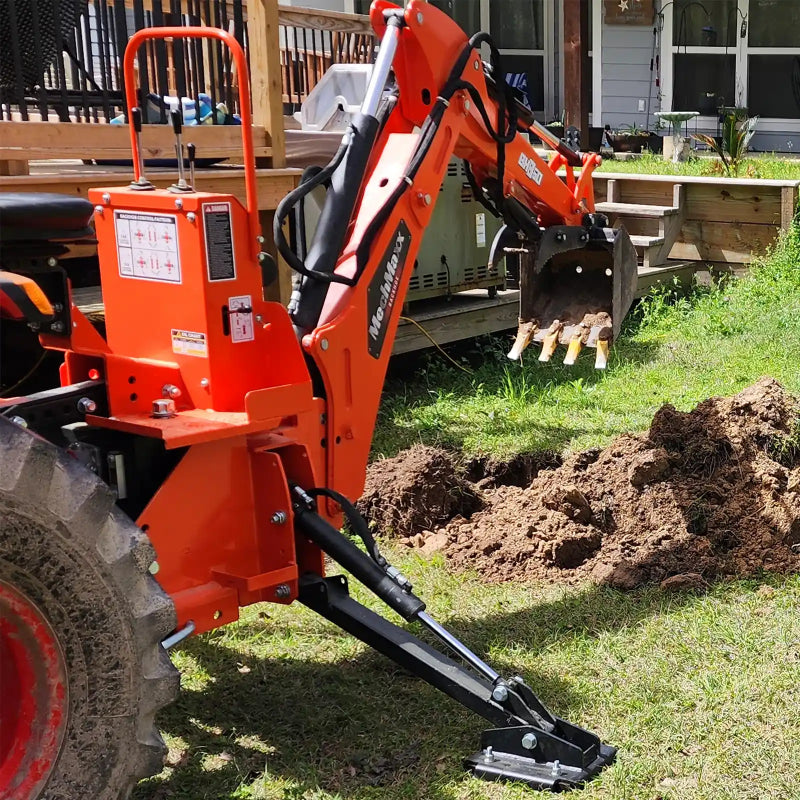 side view of orange MechMaxx BH660 7-foot tractor backhoe attachment digging soil with stabilizer foot at gallery position 1