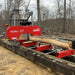 side view of MechMaxx 26" portable sawmill on track cutting large log at gallery position 1