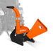 Orange PTO wood chipper with angled feed hopper, curved discharge chute, black frame, and tractor linkage