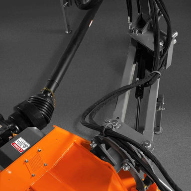 close-up of PTO shaft and hydraulic hoses on orange MechMaxx 86-inch 3-point offset ditch bank flail mower at gallery position 1
