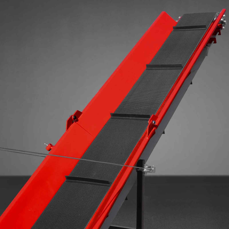 Close-up of red conveyor belt with black cleats on MechMaxx GX390 log splitter processor, gallery position 1 angle view