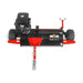 Black and red tow-behind mower with gasoline engine, treaded wheels, red cutting deck, and hitch bar
