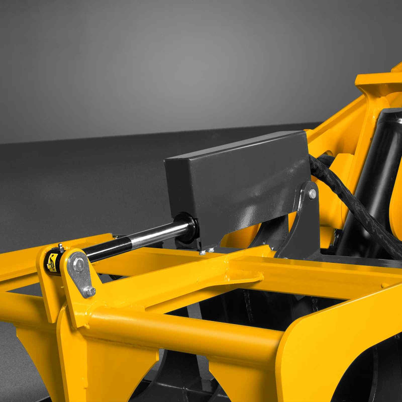 close-up angled view of yellow MechMaxx 42-inch mini skid steer skeleton grapple hydraulic cylinder at gallery position 1