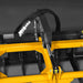 close-up view of yellow MechMaxx mini skid steer grapple attachment hydraulic cylinder and hoses at gallery position 1