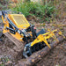 angled view of yellow and black MechMaxx 42-inch mini skid steer skeleton grapple lifting log at gallery position 1