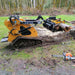 side view of yellow CRT23 mini skid steer with 42-inch skeleton grapple attachment holding log at gallery position 1