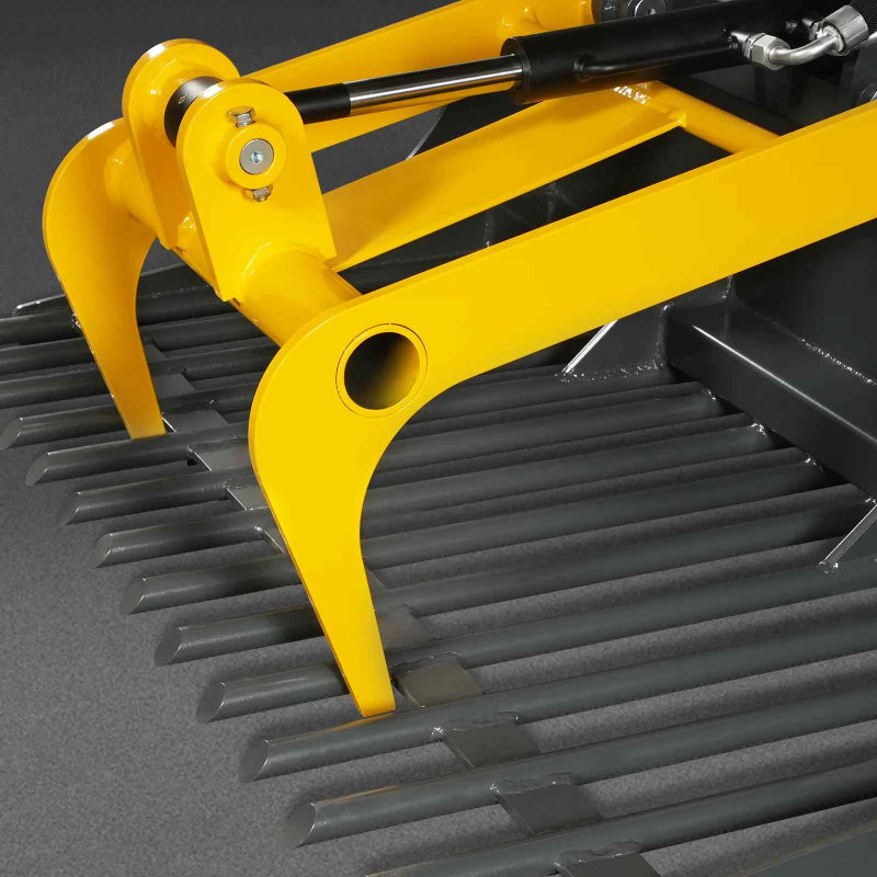 close-up angled view of yellow-mechmaxx 20-inch mini skid steer rock grapple bucket tines and hydraulic cylinders gallery 1