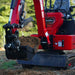 close-up of red MechMaxx MEC10 mini excavator bucket lifting soil with visible hydraulic arm gallery position 1