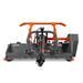 Orange and black brush cutter attachment with PTO shaft, chain curtain, wide cutting deck, and protective side guards