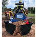 Black steel clamshell bucket attachment with wide scoops filled with mulch connected to a compact loader with hydraulic hoses