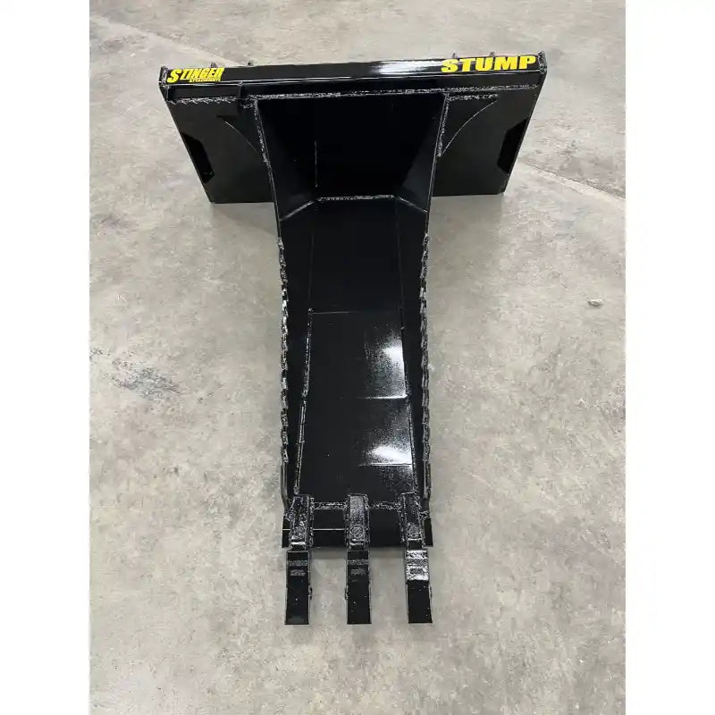 Black metal skid steer stump bucket attachment with narrow tapered body and three digging teeth on concrete floor