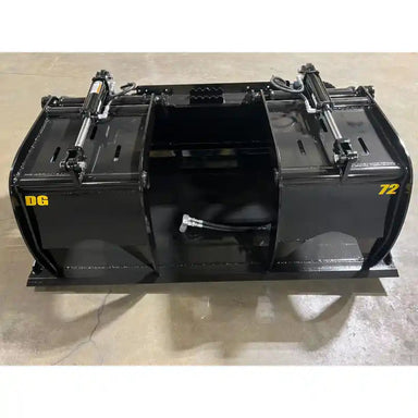 Black steel demolition grapple attachment with dual hydraulic cylinders and clamp arms on concrete floor indoors