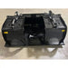 Black steel demolition grapple attachment with dual hydraulic cylinders and clamp arms on concrete floor indoors
