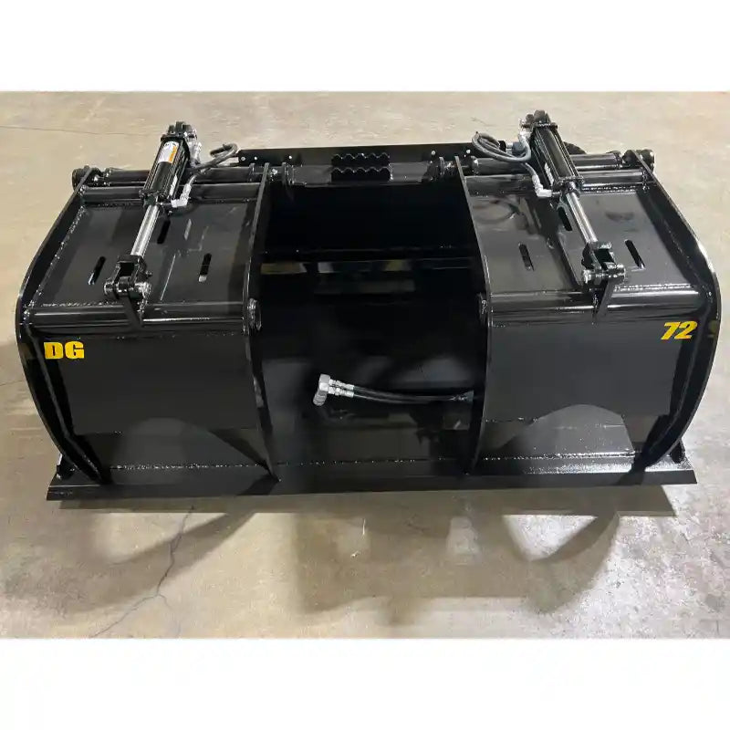 Black steel demolition grapple attachment with dual hydraulic cylinders and clamp arms on concrete floor indoors