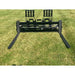Black steel skid steer pallet fork attachment with dual adjustable backrests and long flat fork tines on grass field