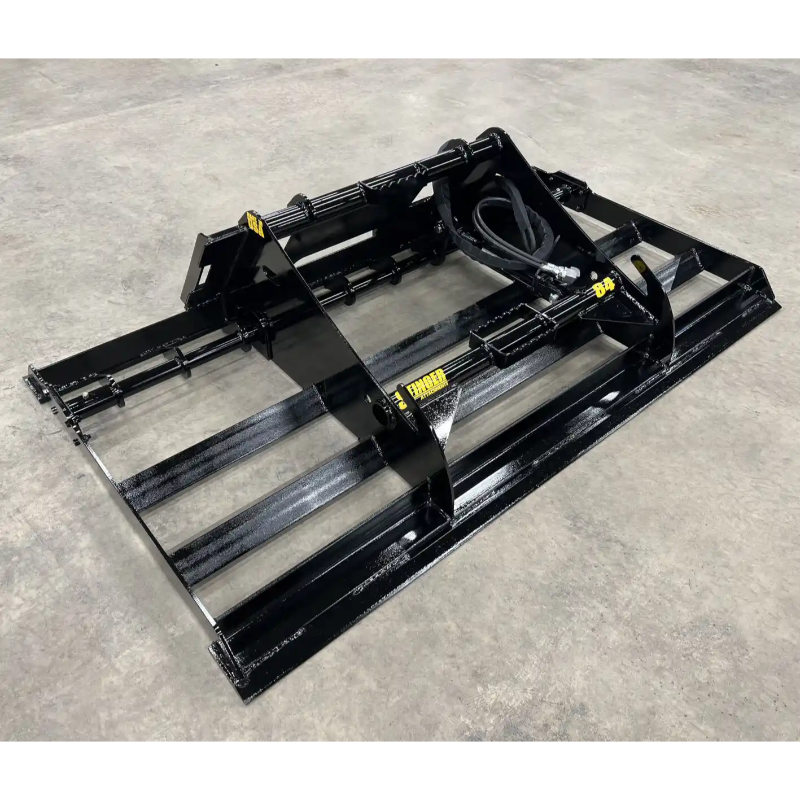Black steel skid steer land plane attachment with hydraulic hoses on concrete surface