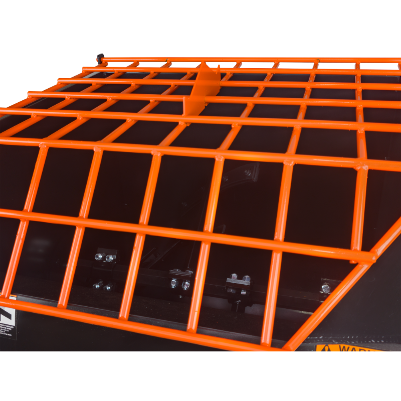 Orange metal safety grate with welded square bars mounted over a black equipment housing panel