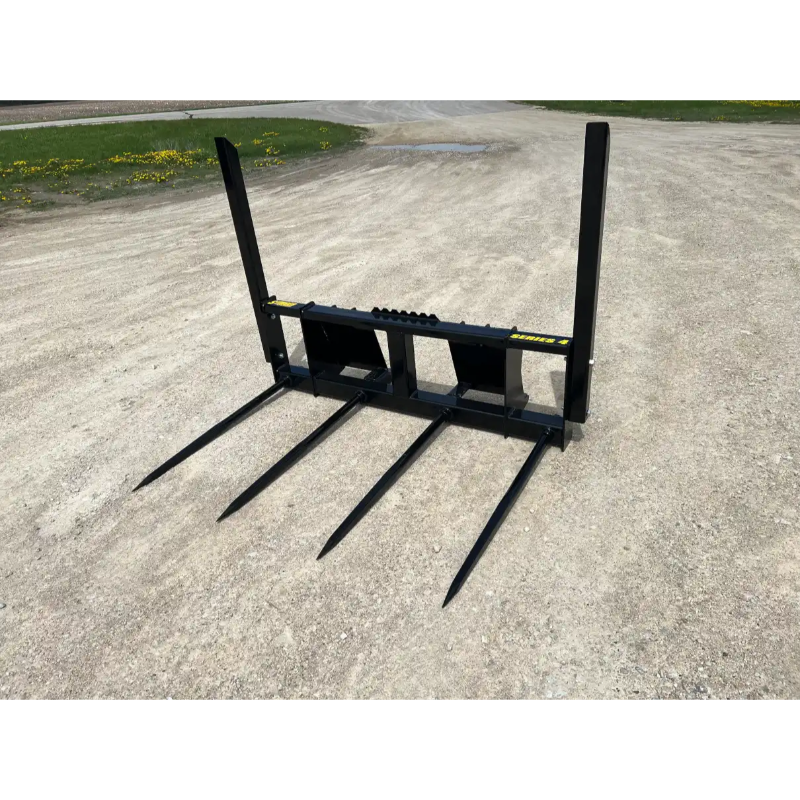 Four-prong black metal attachment for lifting or moving materials on gravel ground outdoors