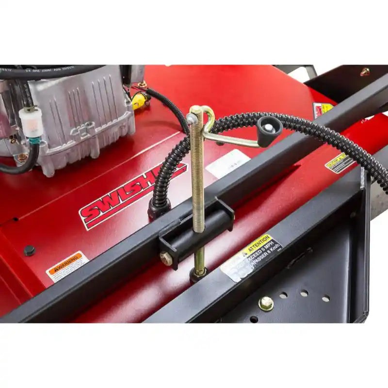 Close-up of height adjustment pin and safety cable on red Swisher 44" rough cut brush mower, gallery position 1